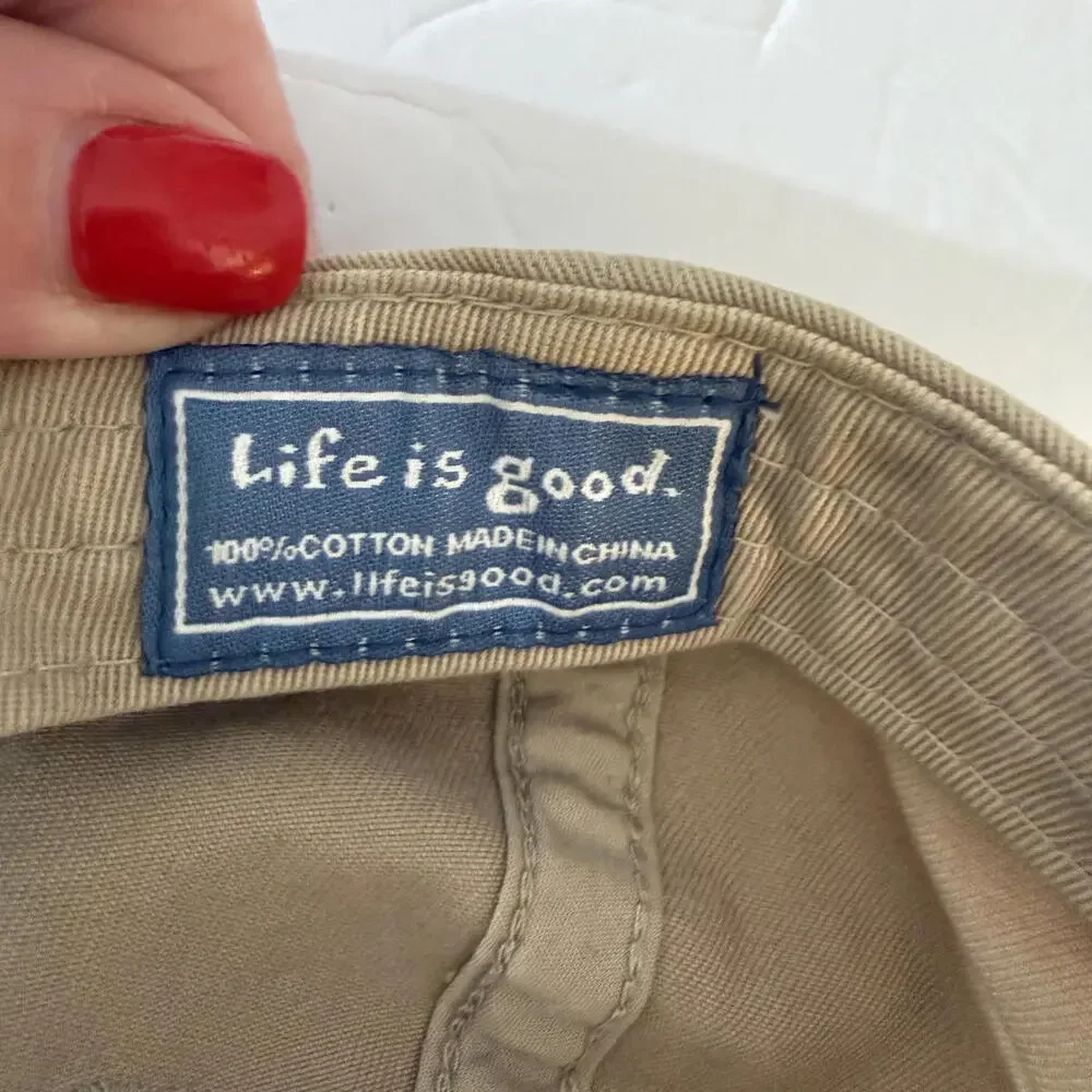 LIFE IS GOOD logo tan baseball hat.  Smile face on back.‎